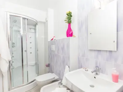 a white bathroom with a sink and a toilet at Stanze del Mare in Balestrate
