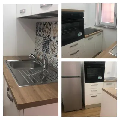 a kitchen with a sink and a stove top oven at La Maison de Claude in Palermo