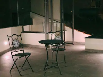 two chairs and a table in a room at La Maison de Claude in Palermo