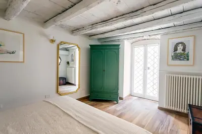 a bedroom with a green cabinet and a mirror at Palazzo Castrone, Luxury Apartment in Palermo