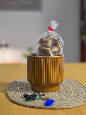a container of donuts in a plastic bag on a table at DorMimmo a Palermo, nel cuore pulsante della città! in Palermo