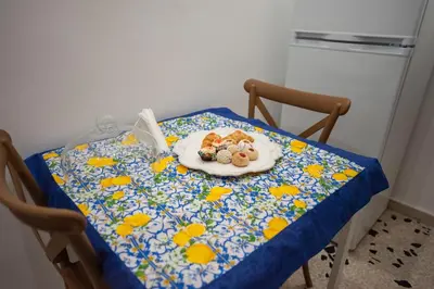 a table with a plate of food on top of it at Holiday House Annunziata 2 in Termini Imerese