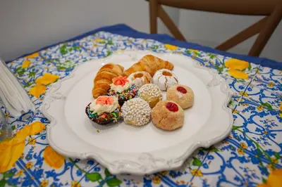 a plate of pastries and croissants on a table at Holiday House Annunziata 2 in Termini Imerese
