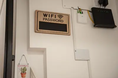 a sign that reads wifi password hanging on a wall at Holiday House Annunziata 2 in Termini Imerese