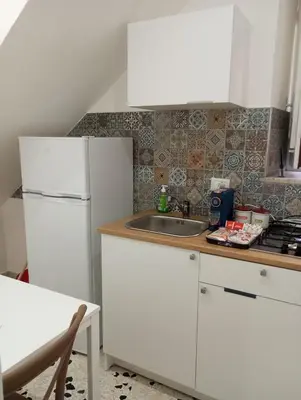 a kitchen with a white refrigerator and a sink at Holiday House Annunziata 2 in Termini Imerese