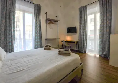 a bedroom with a large bed with two towels on it at Cupola Verde Rooms in Palermo