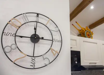 a clock hanging on a wall in a room at Home Simo al Capo in the old center of Palermo in Palermo