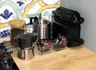 a counter top with a coffee maker and a microwave at Sikelia House - Comfort Apartment in Palermo