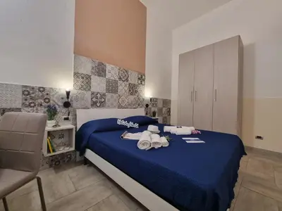 a bedroom with a blue bed with stuffed animals on it at Casa Vulpi by Holiday World in Palermo