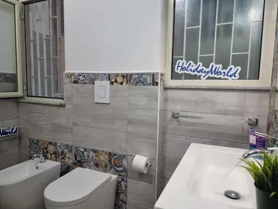 a bathroom with a toilet and a sink at Casa Vulpi by Holiday World in Palermo