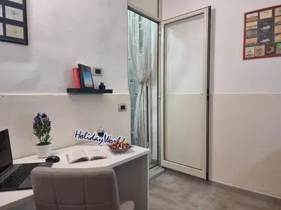 an office with a desk with a laptop and a chair at Casa Vulpi by Holiday World in Palermo