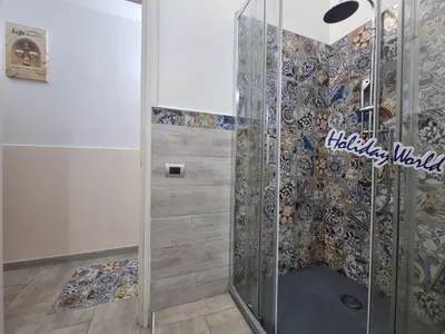 a shower with a glass door in a bathroom at Casa Vulpi by Holiday World in Palermo