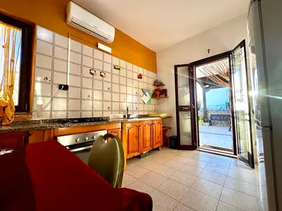 a kitchen with an open door to a patio at Casa del Sole in Campofelice di Roccella