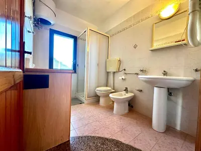 a bathroom with a sink and a toilet at Casa del Sole in Campofelice di Roccella