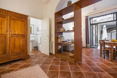 a living room with a kitchen and a dining room at Cortile Galletti - Cool Flat with Private Courtyard in Palermo
