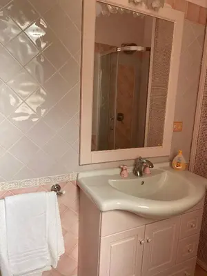a bathroom with a sink and a mirror at Villa Glicine a pochi passi dal mare e dal centro in San Vito lo Capo