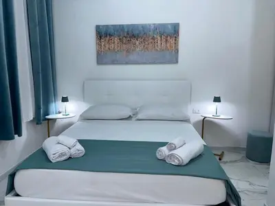 a bedroom with two beds with towels on them at Coco Memi Apartment in Palermo