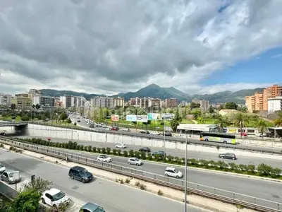 a highway with cars and buildings and a city at Casa Marta in Palermo