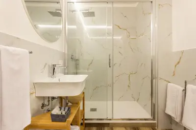 a bathroom with a sink and a shower at Pagano Home Guesthouse in Palermo