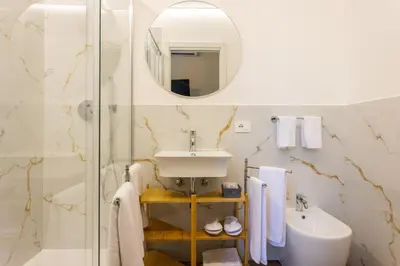 a bathroom with a sink and a mirror at Pagano Home Guesthouse in Palermo