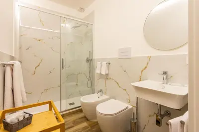 a bathroom with a shower and a toilet and a sink at Pagano Home Guesthouse in Palermo