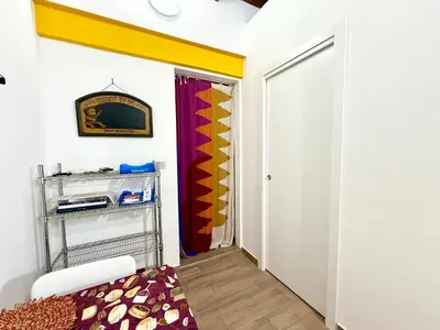 a room with a closet with a door and a rug at Vicolo Giardi in Palermo