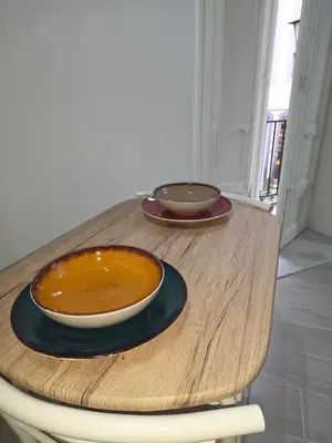 two bowls are sitting on a wooden table at Trasi E Niesci Flat in Palermo