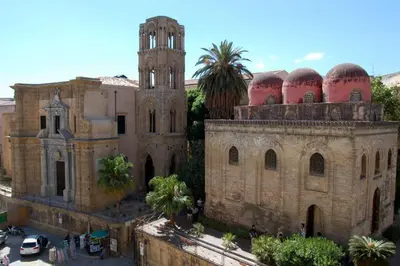 an old building with a tower and a church at Trasi E Niesci Flat in Palermo