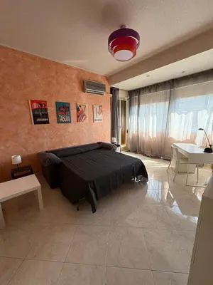 a bedroom with a black bed and a sink at Casaleoni5769 in Palermo