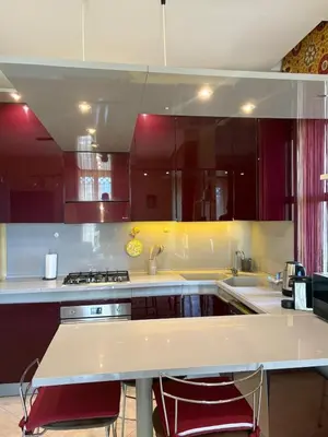 a kitchen with white counters and red cabinets at Casaleoni5769 in Palermo