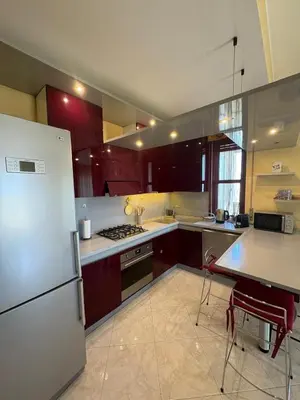 a kitchen with a refrigerator and a table with chairs at Casaleoni5769 in Palermo