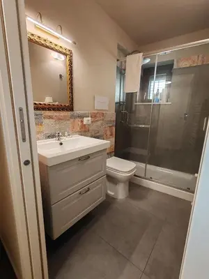 a bathroom with a toilet and a sink and a shower at A fera vecchia by Casa Azzurra Apartments in Palermo