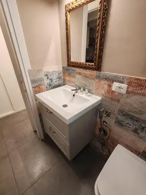 a bathroom with a sink and a mirror and a toilet at A fera vecchia by Casa Azzurra Apartments in Palermo