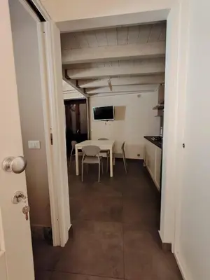 a kitchen and dining room with a table and chairs at A fera vecchia by Casa Azzurra Apartments in Palermo