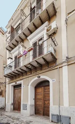 an apartment building with a balcony and a door at BallarHòme 105 