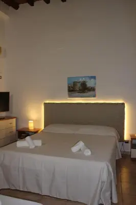 a bedroom with a bed with two white towels on it at Giacalone15 - EXCLUSIVE APARTMENT IN THE HISTORIC CENTER NEAR THE TEATRO MASSIMO in Palermo
