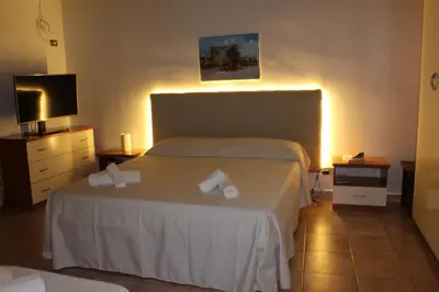 a hotel room with a bed and a television at Giacalone15 - EXCLUSIVE APARTMENT IN THE HISTORIC CENTER NEAR THE TEATRO MASSIMO in Palermo