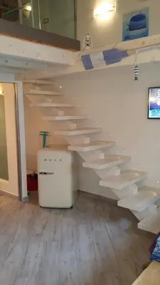 a room with wooden stairs on the wall at La Casetta nel Porto in Castellammare del Golfo