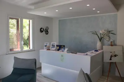 a room with a counter and a chair and a desk at B&B Selene in San Vito lo Capo
