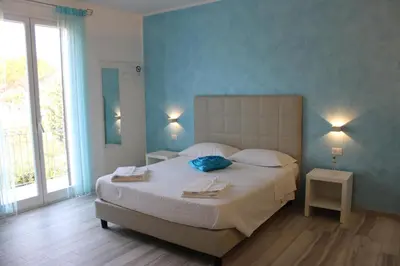 a bedroom with a large bed with two towels on it at B&B Selene in San Vito lo Capo