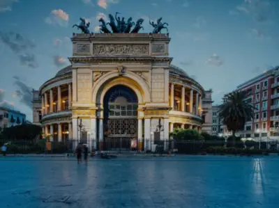 a large building with a statue in front of it at A casa da Carlo al Borgo 2 in Palermo