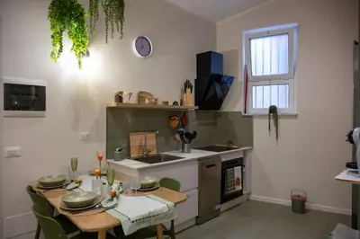 a kitchen with a table and a sink and a stove at A casa da Carlo al Borgo 2 in Palermo