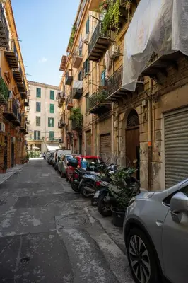 a row of motorcycles parked on the side of a street at A casa da Carlo al Borgo 2 in Palermo