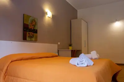 a bedroom with a bed with towels on it at Affittacamere le scale in Castellammare del Golfo