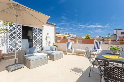 a patio with a table and chairs and an umbrella at The Urban Retreat - Relax in the Historic Center in Palermo