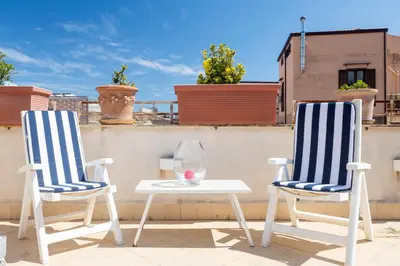 two chairs and a table on a roof at The Urban Retreat - Relax in the Historic Center in Palermo
