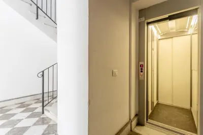 a door in a hallway with a checkered floor at The Urban Retreat - Relax in the Historic Center in Palermo