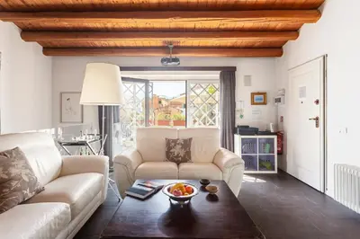 a living room with two white couches and a table at The Urban Retreat - Relax in the Historic Center in Palermo