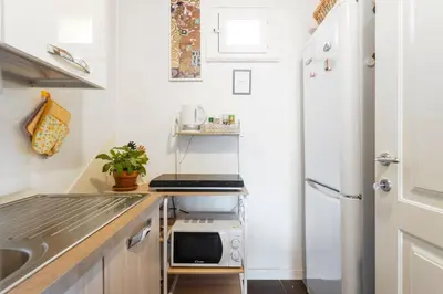 a small kitchen with a sink and a refrigerator at The Urban Retreat - Relax in the Historic Center in Palermo