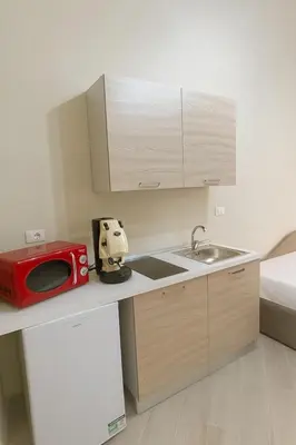 a kitchen with a sink and a microwave on a counter at Isti e Binisti Flat in Palermo
